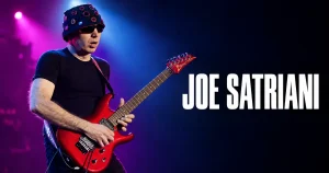 ライブでエレキギターを演奏するジョー・サトリアーニ